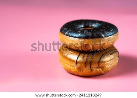 Fresh donuts on a pink background. Royalty-Free Stock Photo #2411118249
