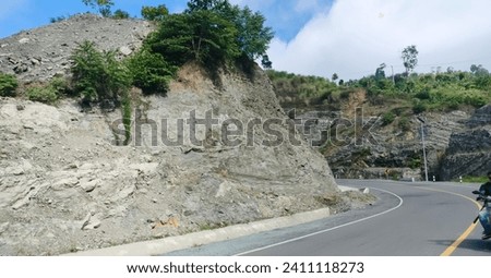 Highway between coastal rock cliffs  Royalty-Free Stock Photo #2411118273