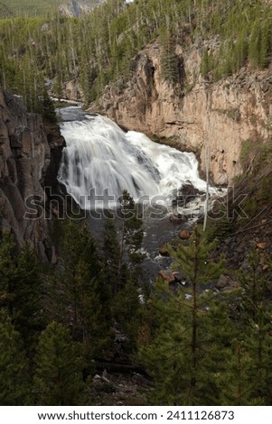 Gibbon Falls waterfall. Yellowstone Park. The photo was taken using a long shutter speed to give the waterfall movement