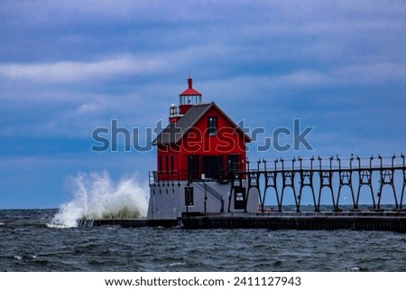 Grand Haven pier in the winter waves crashing Royalty-Free Stock Photo #2411127943