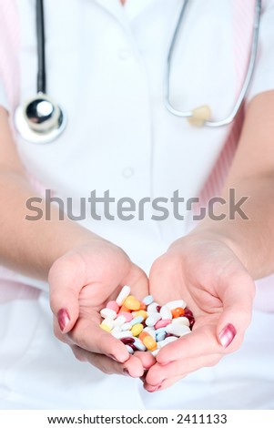 Female doctor handing out pills