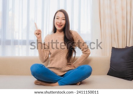 Portrait beautiful young asian woman relax smile happy on sofa decoration interior of bedroom