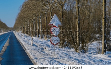 Traffic sign is covered in snow