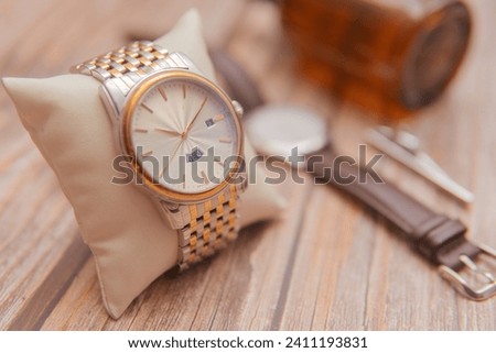 stunning elegant gold timepiece. Swiss made wristwatch with a sleek bracelet. Royalty-Free Stock Photo #2411193831