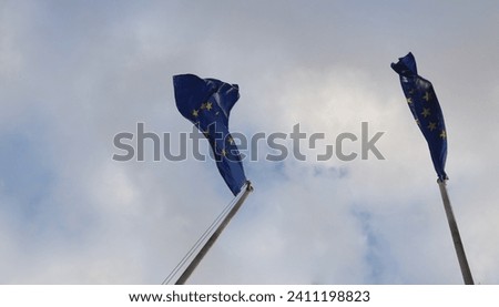 EU European Union Flag waving on pole in the wind on clear blue sky background