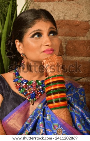 Beautiful bridal portrait of Indian bride wearing blue saree