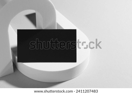 Empty black business card and decorative elements on white background. Mockup for design
