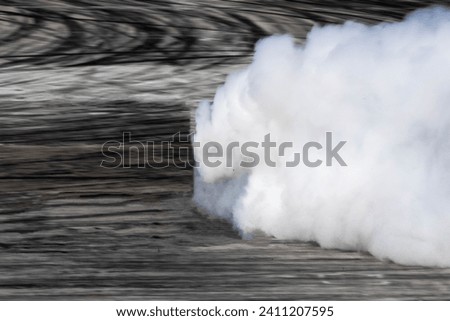 Lots of smoke from burning tires on speed track, Professional driver drifting car on race track with smoke. Royalty-Free Stock Photo #2411207595