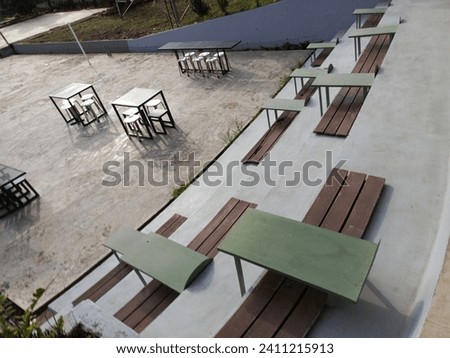 Field view photo with dining table near the stairs. Perfect for magazines, newspapers and tabloids