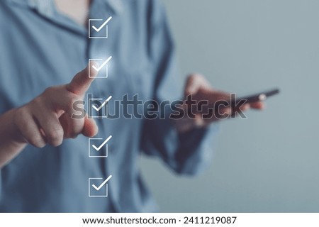 Businessman hand using smartphone and tick correct check mark for accept or approve request action. Checklist, Survey, Assessment, Term of service agreements and Personal Data Protection Act concept.