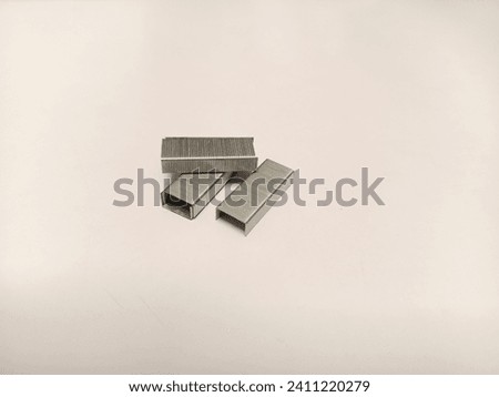 Photo Stack of small metal staples (staplers) isolated on a white background, perfect for magazines, newspapers and tabloids.
