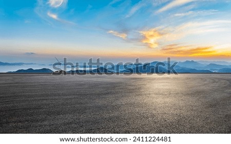 Asphalt road and mountain natural landscape at sunset. High Angle view.