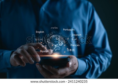 Translator app, language course and e-learning concept. Person use smartphone with Translator app, translation or translate on the mobile app worldwide language conversation speaking concept. Royalty-Free Stock Photo #2411240235