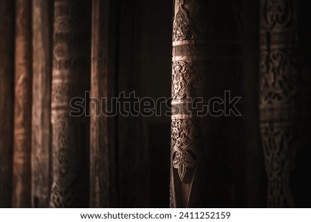 Interior inside the ancient Juma mosque with wooden carved mosaic columns, in the ancient city of Khiva in Khorezm, wood carvings on the columns Royalty-Free Stock Photo #2411252159
