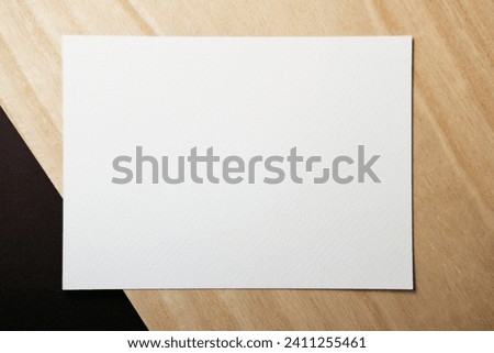Blank business card on wood background. 