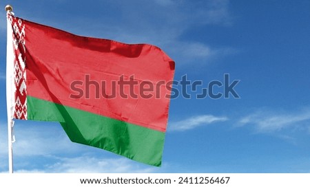 Belarus flag on cloudy sky. flying in the sky Royalty-Free Stock Photo #2411256467