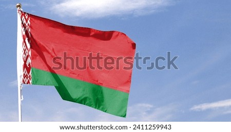 Belarus flag on cloudy sky. flying in the sky Royalty-Free Stock Photo #2411259943