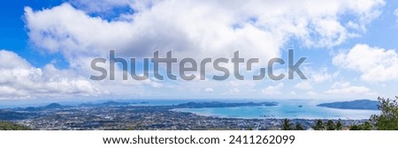 Panoramic photos from a high angle of Phuket where you can see the city, mountains, sky, clouds and the sea. Phuket, Thailand.