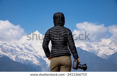 Woman photographer in winter high altitude glacier mountain,China