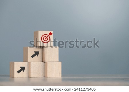 wood cube block with growth according to business goals Royalty-Free Stock Photo #2411273405