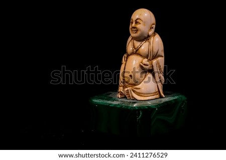 Oriental Buddist Statue Isolated on a Black Background