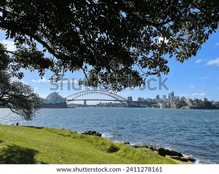 Perfect View of Sydney Opera House and Harbour Bridge with landscaped garden view. Amazing picture mixes the park, ocean, sky, and shadow.