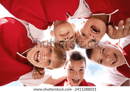 Children, portrait and soccer team huddle or support, happy and collaboration in outdoors. Below, kids and boys together for match and partnership, smiling and solidarity in circle by sky background