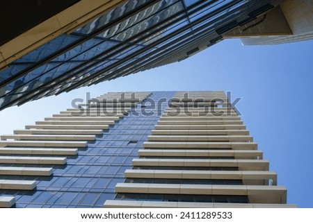 Urban canyon: Perspective view of towering skyscrapers against sky.