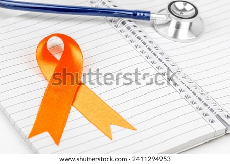 Cancer awareness concept with ribbon on doctor table. World Cancer Day card