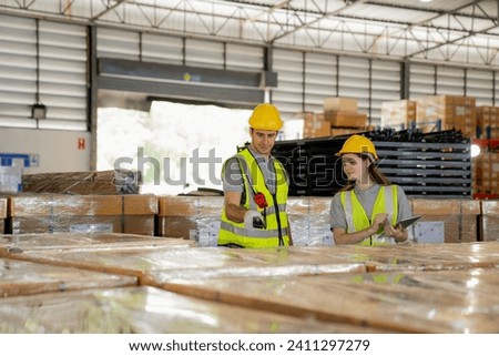 Warehouse worker and managers check stock and inventory by using digital tablet computer in the retail warehouse full of shelves with goods. Working in logistics and distribution center.