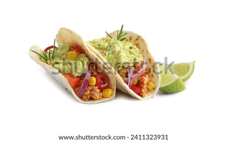 Delicious tacos with guacamole, vegetables and slices of lime isolated on white