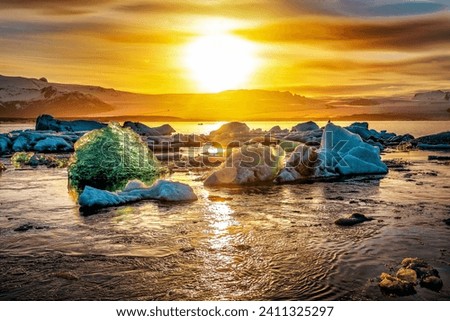 Iceland, Jokulsarlon lagoon, Beautiful cold landscape picture of icelandic glacier lagoon bay with iceberg at sunset or sunrise
