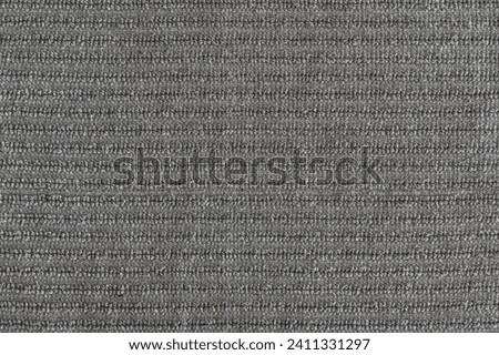 abstract background of grey furniture upholstery with ribbed trim texture close up