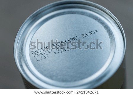 Best before date on aluminium can. Close up view with narrow depth of field. Royalty-Free Stock Photo #2411342671