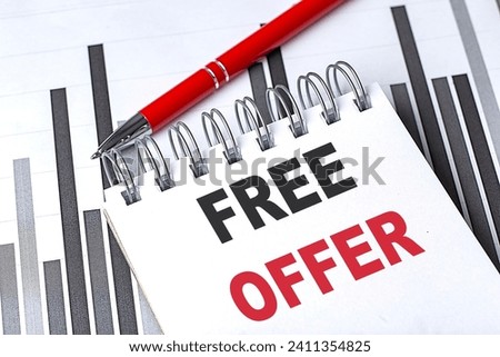FREE OFFER text written on a notebook with pen on chart
