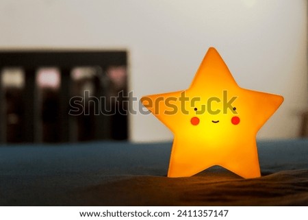 Decorative star with a background crib and colorful balls on the wall. Decorative star concept. Sleep concept.
