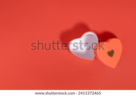 Flat lay view of St Valentine open heart box on red background with copy space