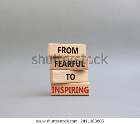 From Fearful to Inspiring symbol. Concept words From Fearful to Inspiring on wooden blocks. Beautiful grey background. Business and From Fearful to Inspiring concept. Copy space.