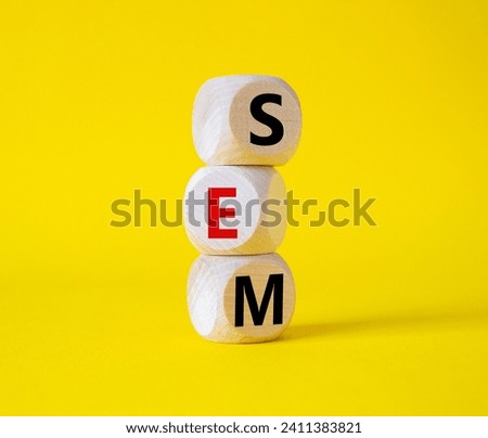 SEM - Search Engine Marketing symbol. Wooden cubes with words SEM. Beautiful yellow background. Business and SEM concept. Copy space.