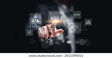 Agile development methodology concept, businessman touch virtual screen of agile icons for process that will help you work faster By reducing step-by-step work and focusing on team communication.