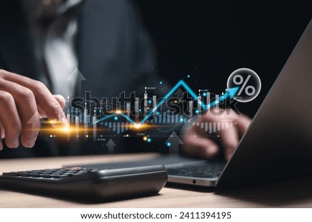 Interest rate and dividend concept, Businessman using laptop analyzing the economic growth graph for investment growth. business financial investment, business growth, income, marketing and profit. Royalty-Free Stock Photo #2411394195