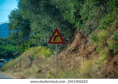 Traffic sign with an arrow indicating a curve in corfu island,Greece