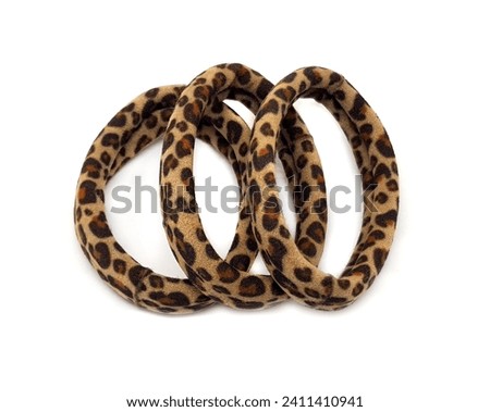 Hair tie with leopard print on a white background. Fashionable hair bands