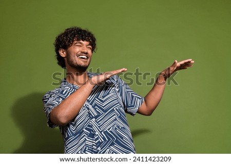 Photo of young carefree indian guy wear shirt dance raised hands just chill at summer late night party isolated on khaki color background