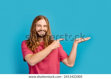 Portrait of positive person indicate finger hand hold empty space proposition isolated on blue color background