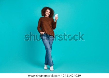Full size photo of pretty young girl instagram twitter facebook telegram device wear trendy brown outfit isolated on cyan color background