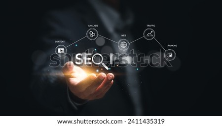 Businessman hold virtual SEO icon to analyze SEO search engine optimization for promoting ranking traffic on website and optimizing your website to rank in search engines. Royalty-Free Stock Photo #2411435319