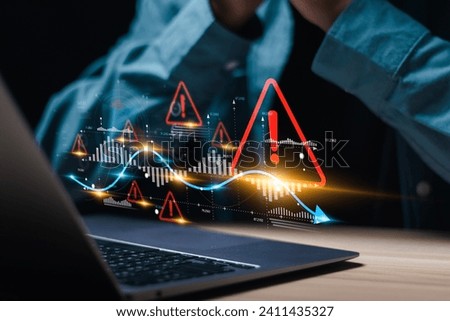 Businessman use laptop with virtual world economic growth chart with red warning sign for caution in investing economic situation warning, Business investment risks. Royalty-Free Stock Photo #2411435327
