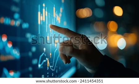 Finger pointing Stock Market screen - a hand touching a screen showing graphics Royalty-Free Stock Photo #2411454351