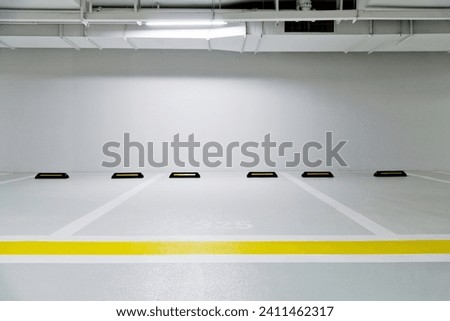 Empty parking garage in modern apartment. Royalty-Free Stock Photo #2411462317